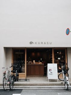 two bikes parked in front of a store