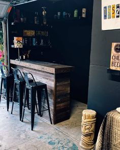 an outdoor bar with stools next to it