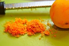 an orange peel on a cutting board next to a knife and some other food items