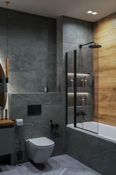 a bathroom with a toilet, sink and bathtub next to a mirror on the wall