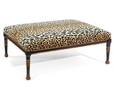 a leopard print footstool sitting on top of a white floor