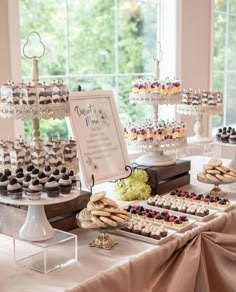 an assortment of desserts and pastries on a table