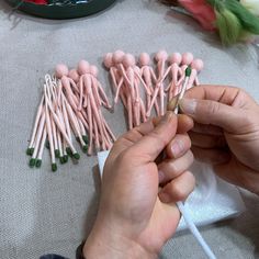 someone is making pink and green candles out of marshmallows