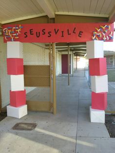 an entrance to a building with red and white striped pillars on either side of it