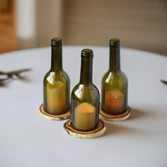 three wine bottles sitting on top of a table