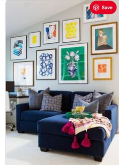 a living room filled with furniture and pictures on the wall