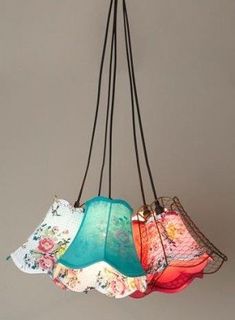 a bunch of different colored lamps hanging from a ceiling