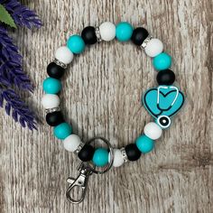 a bracelet with a medical charm on it and a keychain attached to it