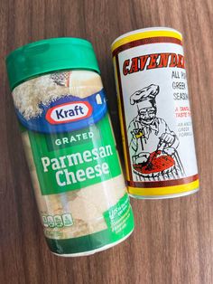 two containers of parmesan cheese next to each other on a wooden table top