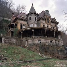 an old house sitting on top of a hill