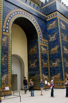 people are standing in front of an ancient building