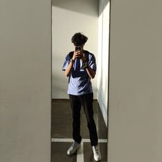 a person taking a photo in the mirror