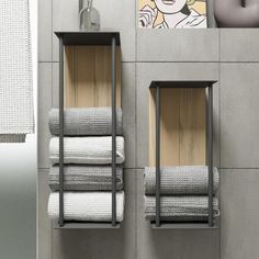 two metal shelves with towels on them in a bathroom