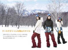 three snowboarders are posing in the snow