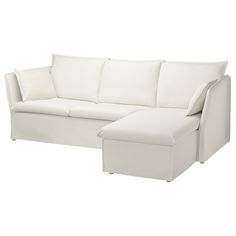 a white couch with pillows and a footstool