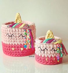 two pink baskets with unicorns on them sitting next to each other