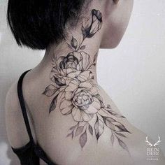 the back of a woman's neck with flowers on it