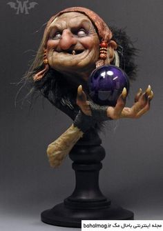 a creepy looking troll holding a purple ball on top of a black stand with one hand