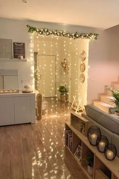 a living room filled with furniture and christmas lights