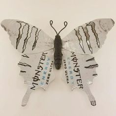 a butterfly made out of plastic with the words water on it's back wings