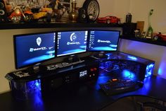 three computer monitors sitting on top of a desk