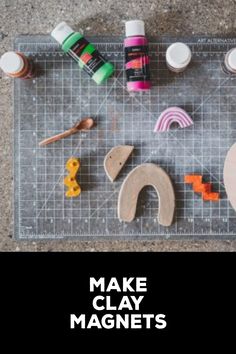 the words make clay magnets are laid out on a cutting board next to craft supplies