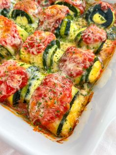 a square casserole dish with zucchini and tomatoes