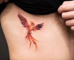 a woman's stomach with a bird tattoo on it