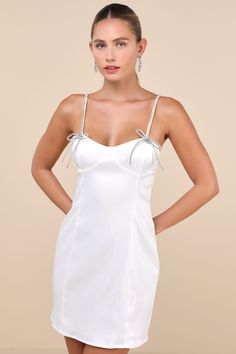 The Glamorous Bling Beauty White Satin Rhinestone Bustier Mini Dress will always make you the talk of any party! Super sleek woven satin shapes this flirty lil' dress that features a bustier-inspired design with seamed cups, a sweetheart neckline, and extra slender straps adorned with sparkling rhinestones and bedazzled bows at the front. The classic bodycon silhouette will effortlessly flatter your figure as it falls to a too-cute mini hem. Hidden back zipper/clasp. Fit: This garment fits true Rhinestone Bustier, Bustier Mini Dress, Adhesive Bra, The Talk, Strapless Bra, White Satin, Dress 100, Large Size Dresses, Sweetheart Neckline