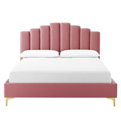 an upholstered bed with pink velvet headboard and white pillows on the bottom