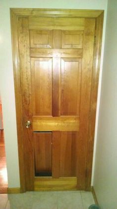 a wooden door in a room with tile flooring