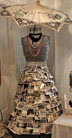 a dress made out of newspapers and an umbrella