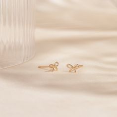 Our Tiny Bow Stud Earrings add the perfect bit of sweetest to any occasion. Whether it’s a romantic dinner out or a quick morning coffee run, these earrings can go with you anywhere - and they’re 14k solid gold, so they’re sure to last. Perfect for a gift for a friend, and even better as a gift for yourself! DETAILS 14k solid gold studs with 14k butterfly backs 6mm bow Comes as a pair Safe for sensitive skin & shower safe Love Knot Ring, Diamond Initial Necklace, Solid Gold Bracelet, Coffee Run, Tiny Bow, Diamond Jewelry Necklace, Solid Gold Necklace, Solid Gold Earrings, Romantic Dinner