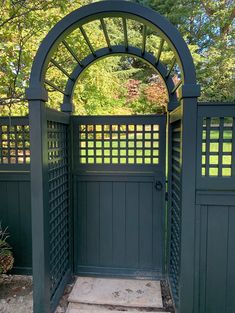 an open gate in the middle of a garden