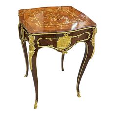 an ornately decorated wooden table with gold accents