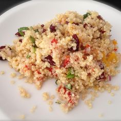 a white plate topped with rice and veggies