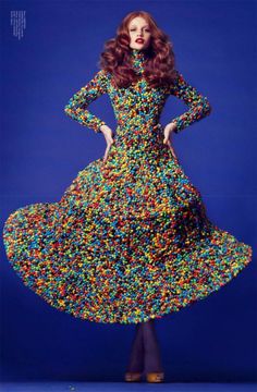 a woman in a dress made out of sprinkles on a blue background