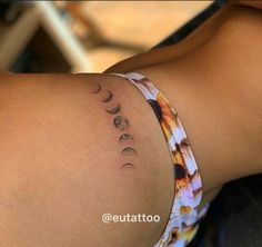 a woman's back with the moon phases tattooed on her left side and right arm