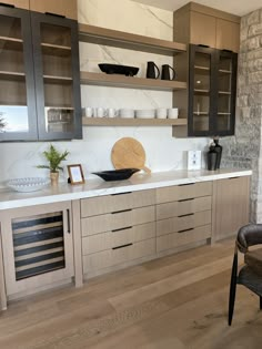 a kitchen with wooden cabinets and marble counter tops