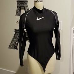 Nike... Black Bodysuit... With White Trim.....Women's Large Nike Bodysuit Outfit, Black Sporty Bodysuit For Sports, Nike Bodysuit, Nike Bodysuit For Swimming, Nike Black Fitted Bodysuit, Nike One-piece Bodysuit For Swimming, Black Sporty One-piece Bodysuit, Nike Romper, Long Sleeve Mesh Bodysuit