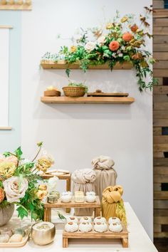 a table topped with lots of different types of cakes and cupcakes on top of wooden trays