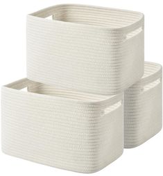 two white storage baskets sitting next to each other