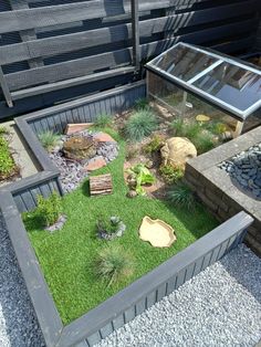 a small garden with rocks and grass