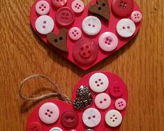 two hearts shaped like buttons on a wooden table