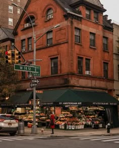 an old brick building with a green awning on the corner in front of it