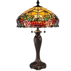 a lamp that is sitting on top of a table with a flower design on it