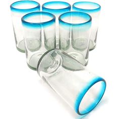 six shot glasses with blue rims are lined up