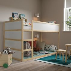 a child's bedroom with bunk beds and toys on the floor in front of it