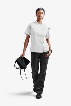 Now you see a spill – now you don’t! The reversible front closure on this double-breasted Stretch Chef Coat handles messy situations in a flash. Short sleeves keep you cool. A back vent adds wearing ease. No matter the temperature of the oven or the pace of your kitchen, Chef 360 always gives you 360 degrees of movement and comfort • Classic fit • Stand collar • Double breasted • Reversible front closure • Buttons have ChefUniforms.com logo • 1 pocket for pen/thermometer on left sleeve • Short s Chef Coats, Chef Uniforms, Bistro Apron, Chef Wear, Chef Uniform, Compression Wear, Chef Coat, Easy Stretches, Reversible Coat