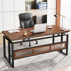 an office desk with a laptop on it